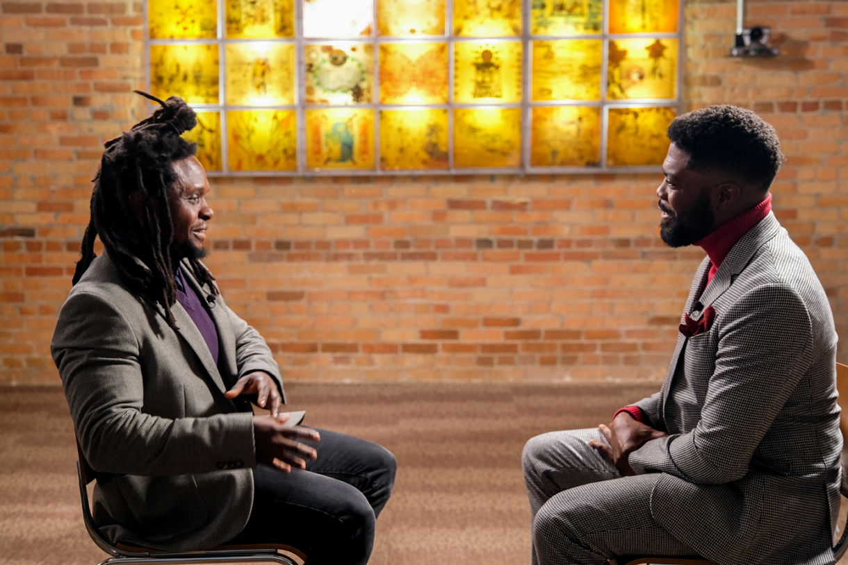 two men sitting face to face during an interview  