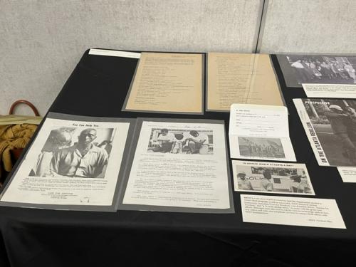 a collection of archival material lay displayed on a table